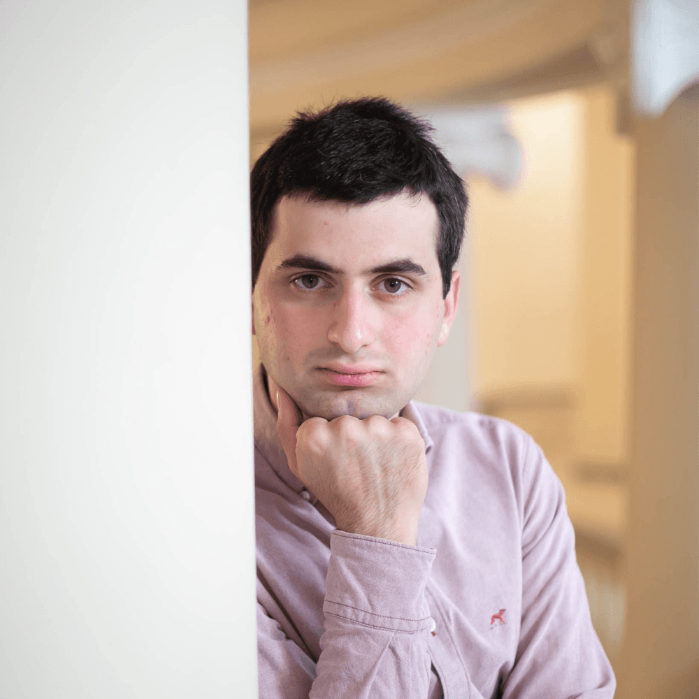 Pianist on stage under spotlight